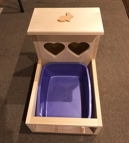 Bunny rabbit hay feeder with attached litter tray and heart shaped hay holes